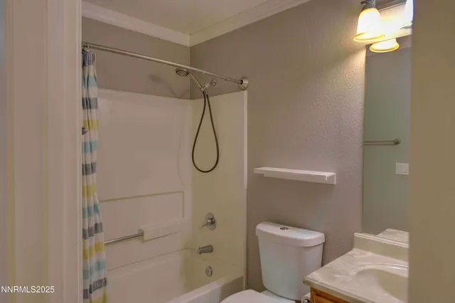 a bathroom with a shower a toilet and a shower