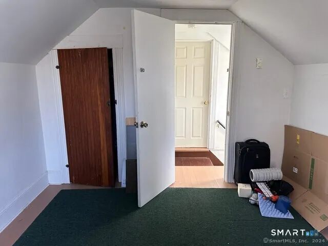 a view of a workspace and bedroom with furniture