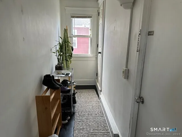 a view of a hallway with wooden floor