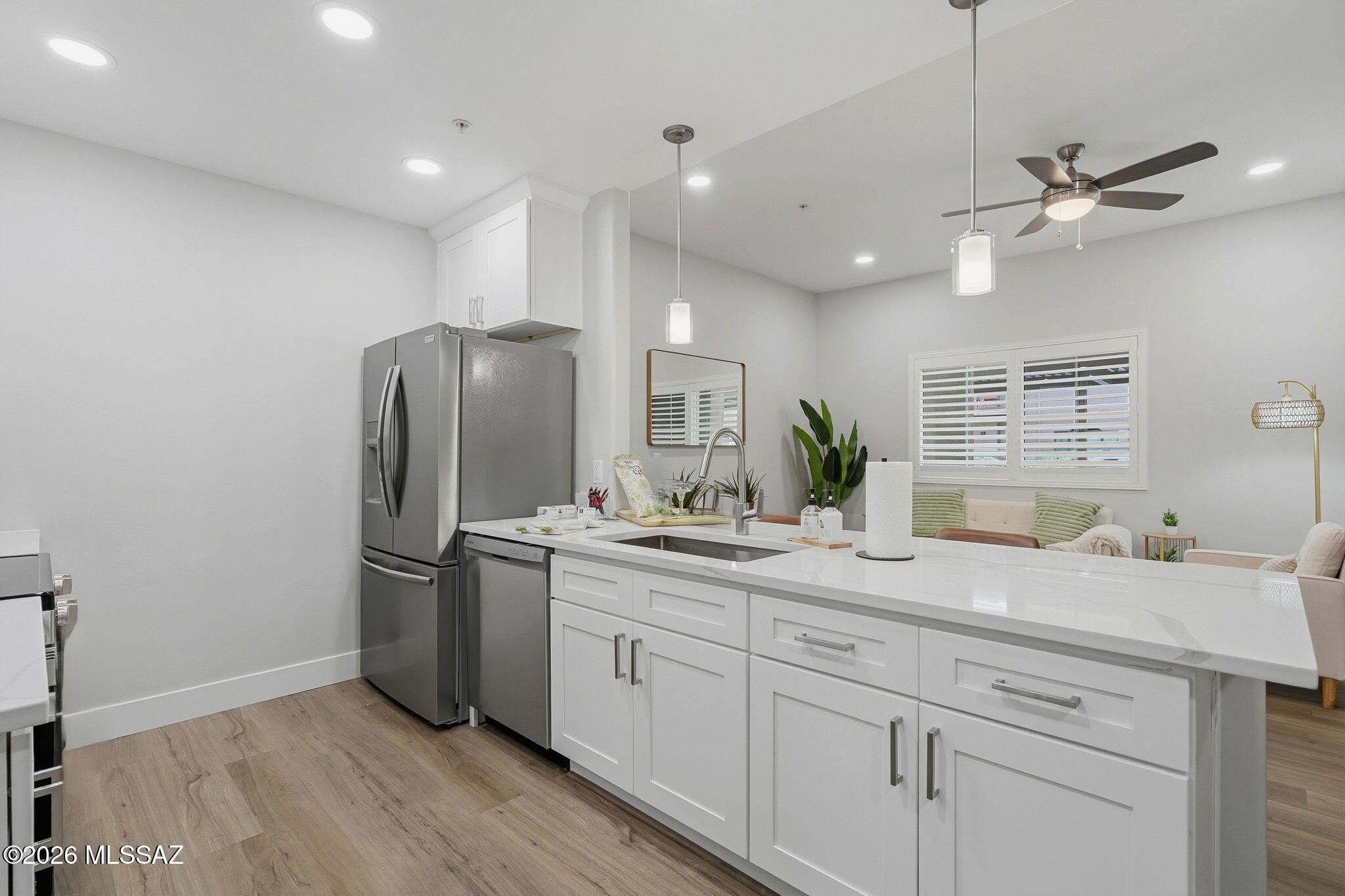 2020 East River Road, Unit 101 Tucson, AZ 85718 - Photo 4 of 12 a kitchen with a refrigerator sink and cabinets