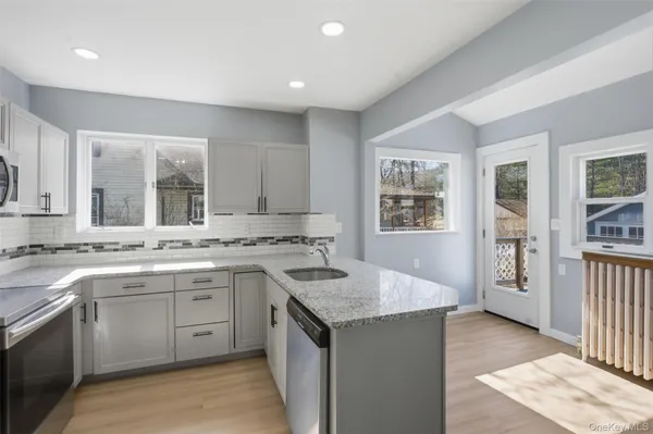 a kitchen with a sink stove and cabinets
