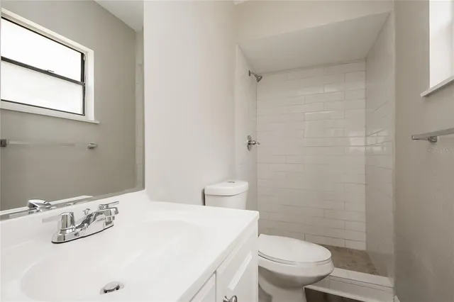 a bathroom with a sink a toilet and shower curtain