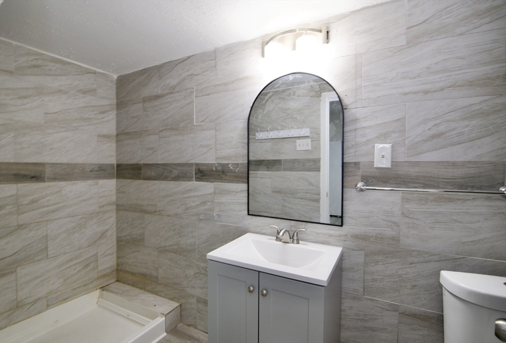 19 Greene Place Springfield, MA 01109 - Photo 13 of 36 a bathroom with a sink a toilet and mirror