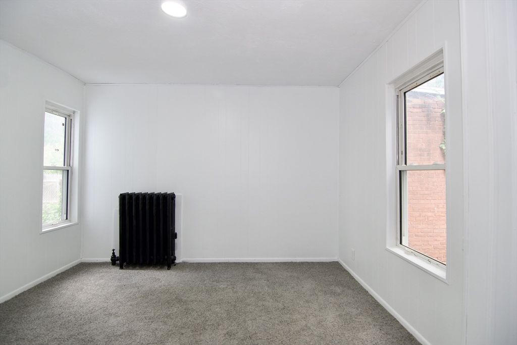 19 Greene Place Springfield, MA 01109 - Photo 21 of 36 an empty room with windows and closet