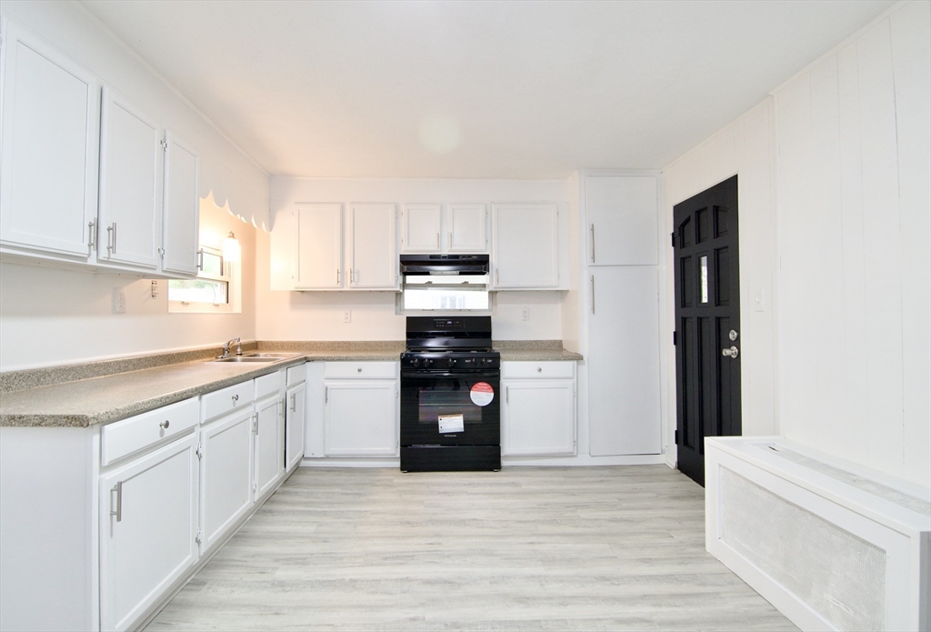19 Greene Place Springfield, MA 01109 - Photo 3 of 36 a kitchen with granite countertop a refrigerator stove top oven and sink