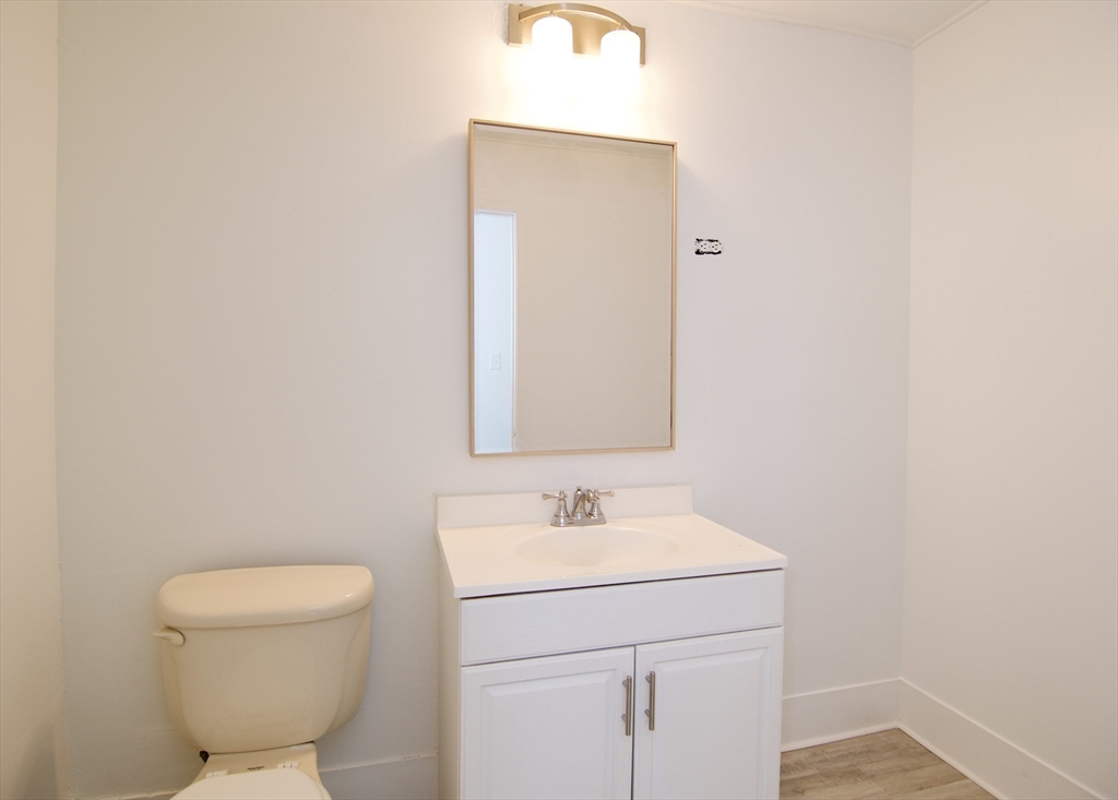 19 Greene Place Springfield, MA 01109 - Photo 33 of 36 a bathroom with a sink a toilet and a mirror