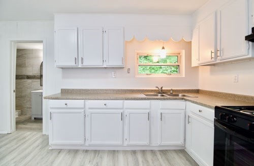 19 Greene Place Springfield, MA 01109 - Photo 4 of 36 a kitchen with white cabinets white appliances and sink