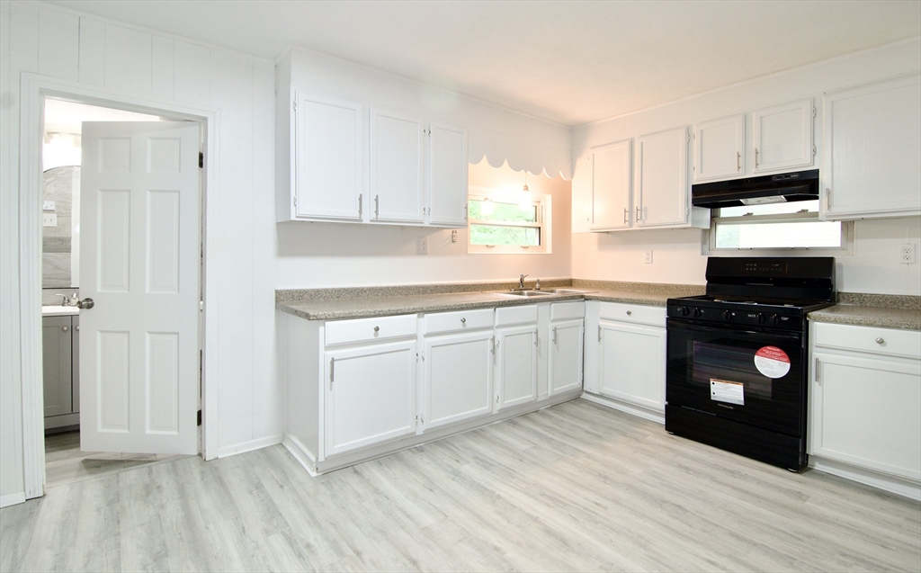 19 Greene Place Springfield, MA 01109 - Photo 5 of 36 a kitchen with a white cabinets and wooden floor