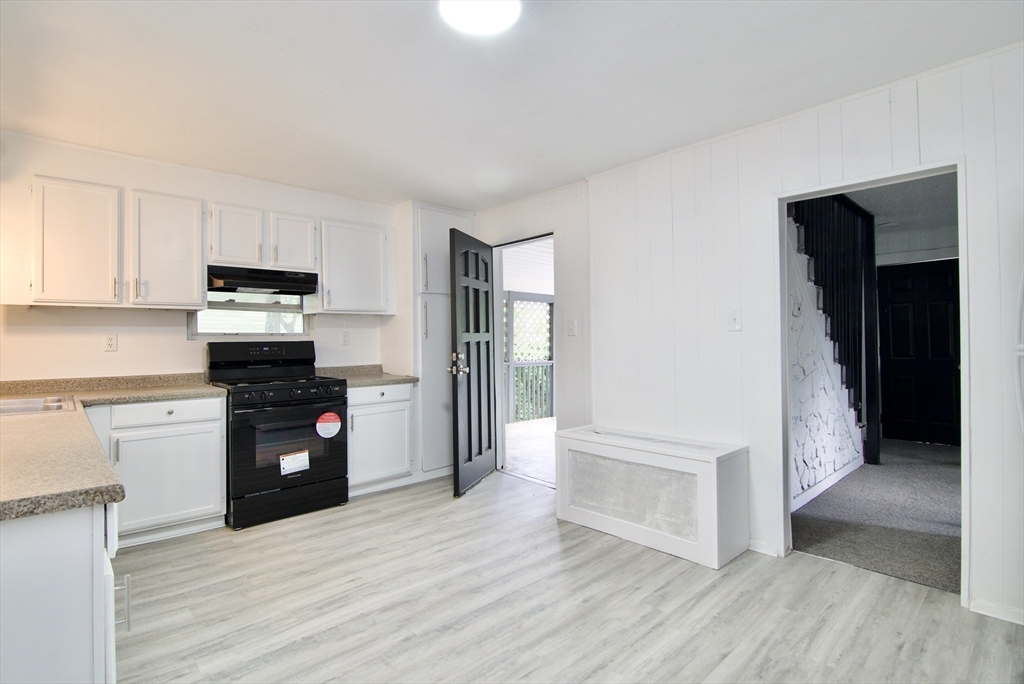 19 Greene Place Springfield, MA 01109 - Photo 9 of 36 a kitchen with granite countertop a refrigerator and a stove top oven