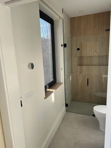 a bathroom with a shower and a toilet