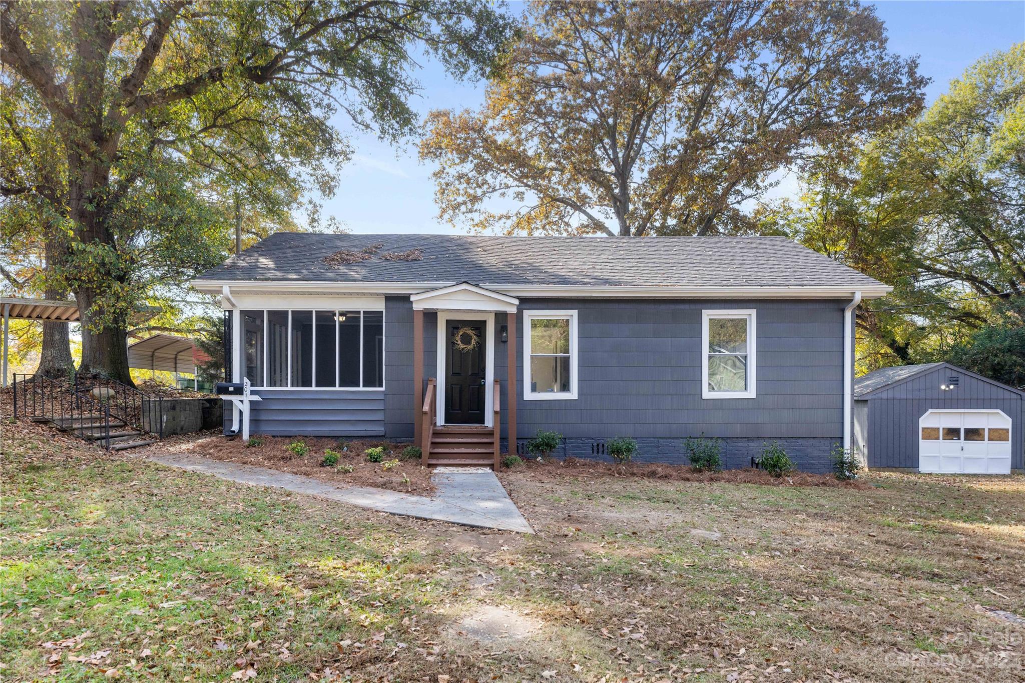 a view of house with outdoor seating and yard