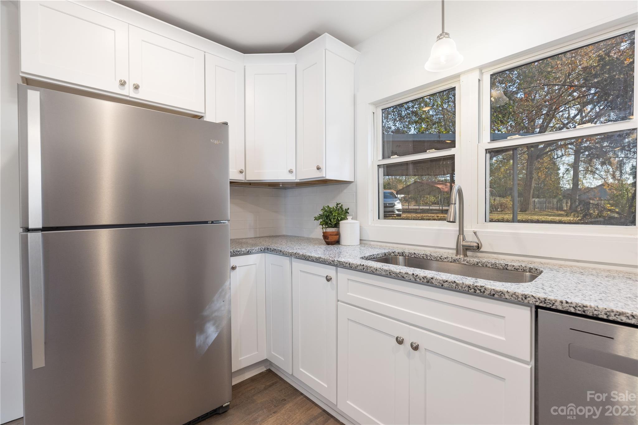 201 Hicks Circle Mount Holly, NC 28120 - Photo 12 of 23 a kitchen with granite countertop a refrigerator sink and cabinets