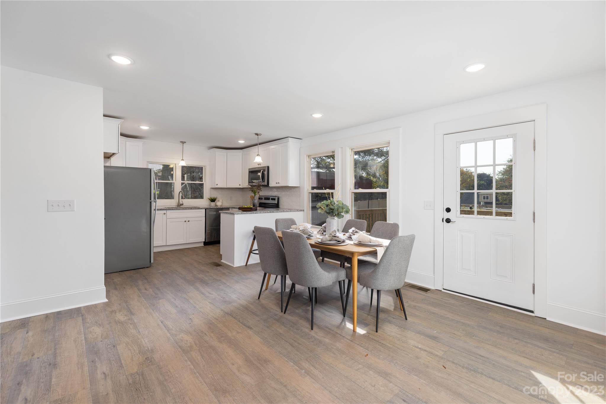 201 Hicks Circle Mount Holly, NC 28120 - Photo 13 of 23 a view of a dining room with furniture and wooden floor