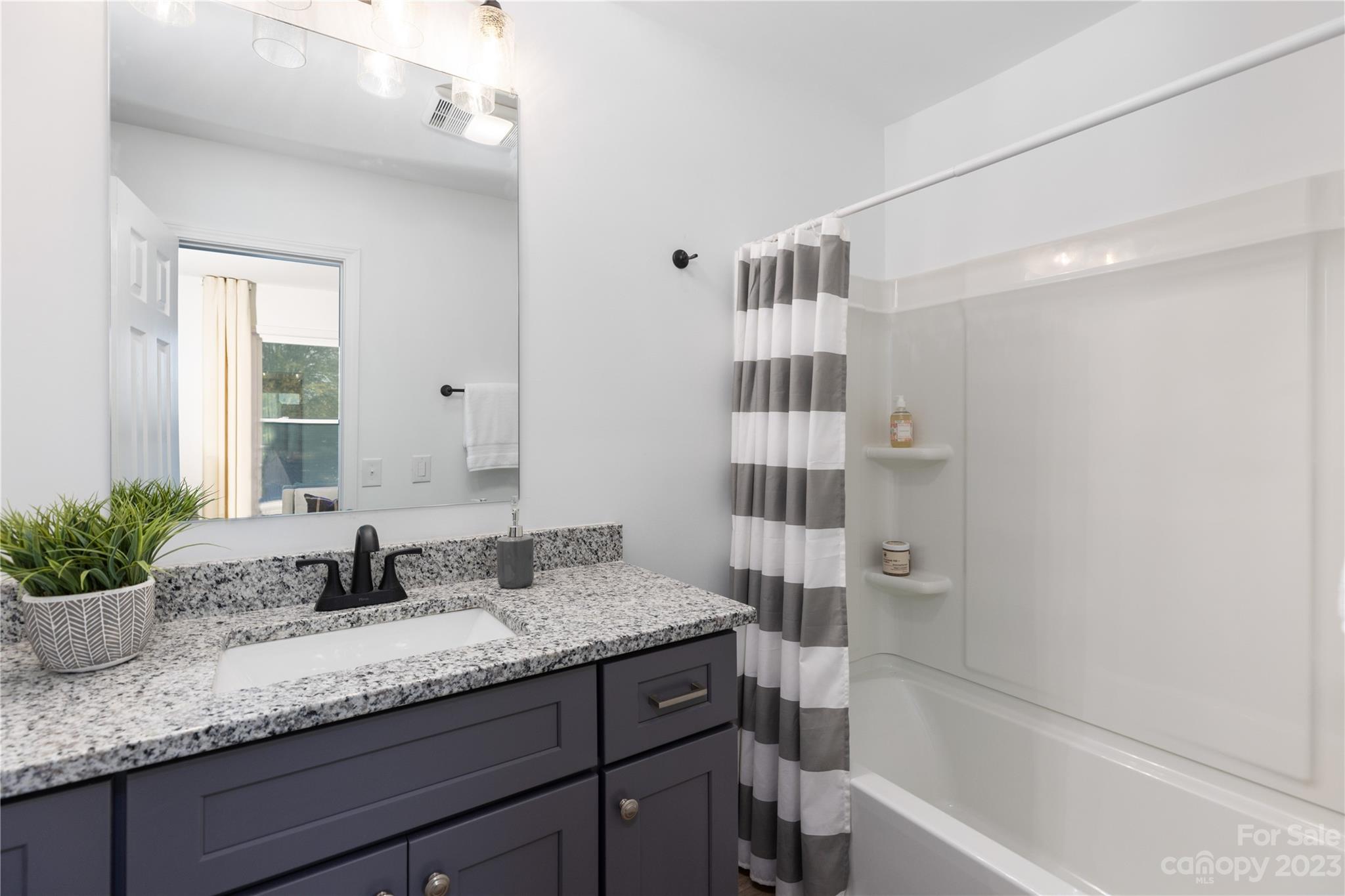 201 Hicks Circle Mount Holly, NC 28120 - Photo 21 of 23 a bathroom with a granite countertop sink and a mirror