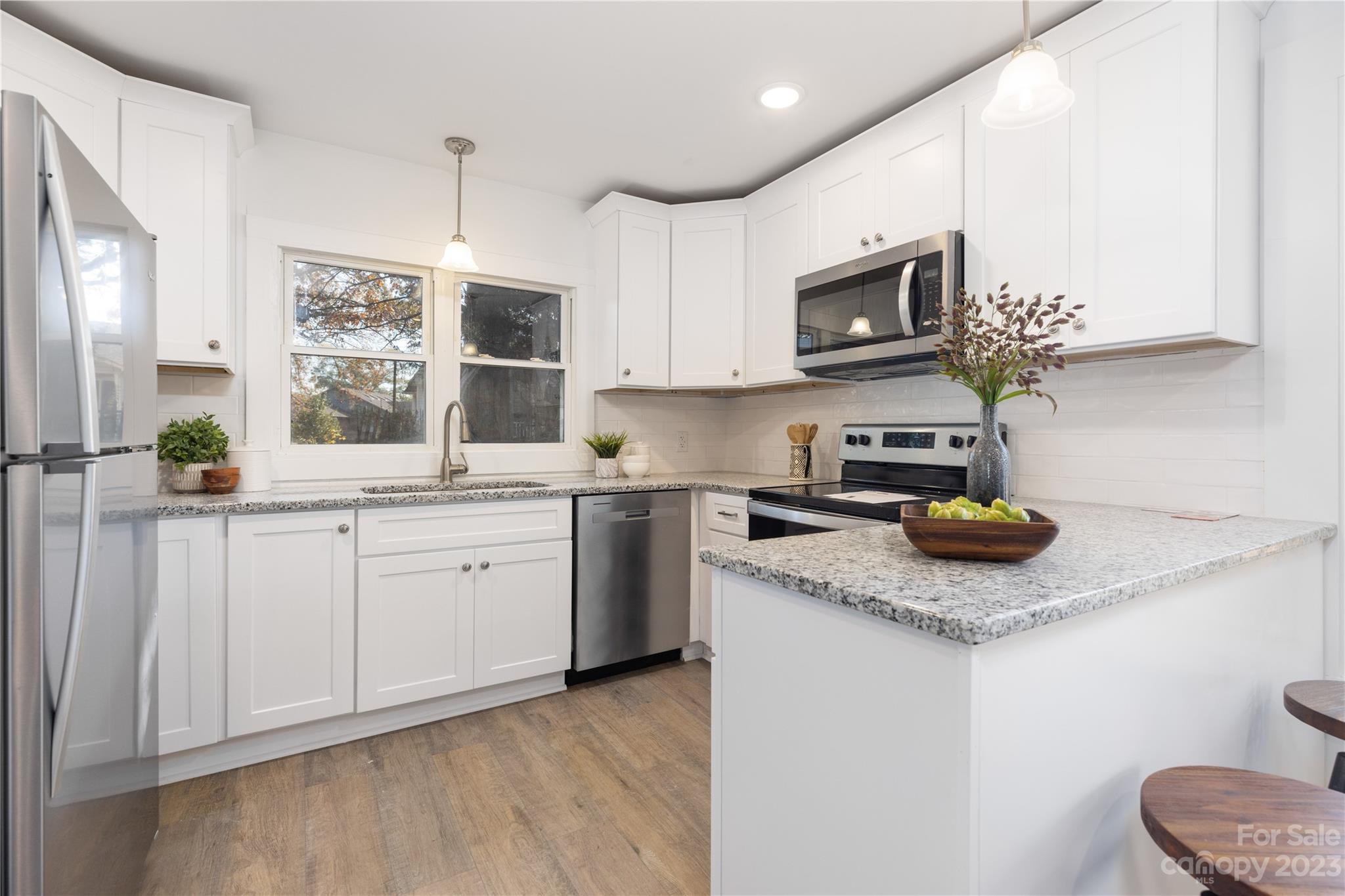 201 Hicks Circle Mount Holly, NC 28120 - Photo 8 of 23 a kitchen with stainless steel appliances granite countertop a sink a stove a microwave a refrigerator and cabinets