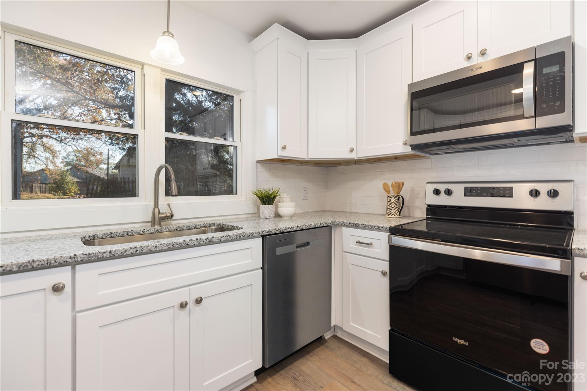 201 Hicks Circle Mount Holly, NC 28120 - Photo 9 of 23 a kitchen with stainless steel appliances granite countertop white cabinets and a stove top oven