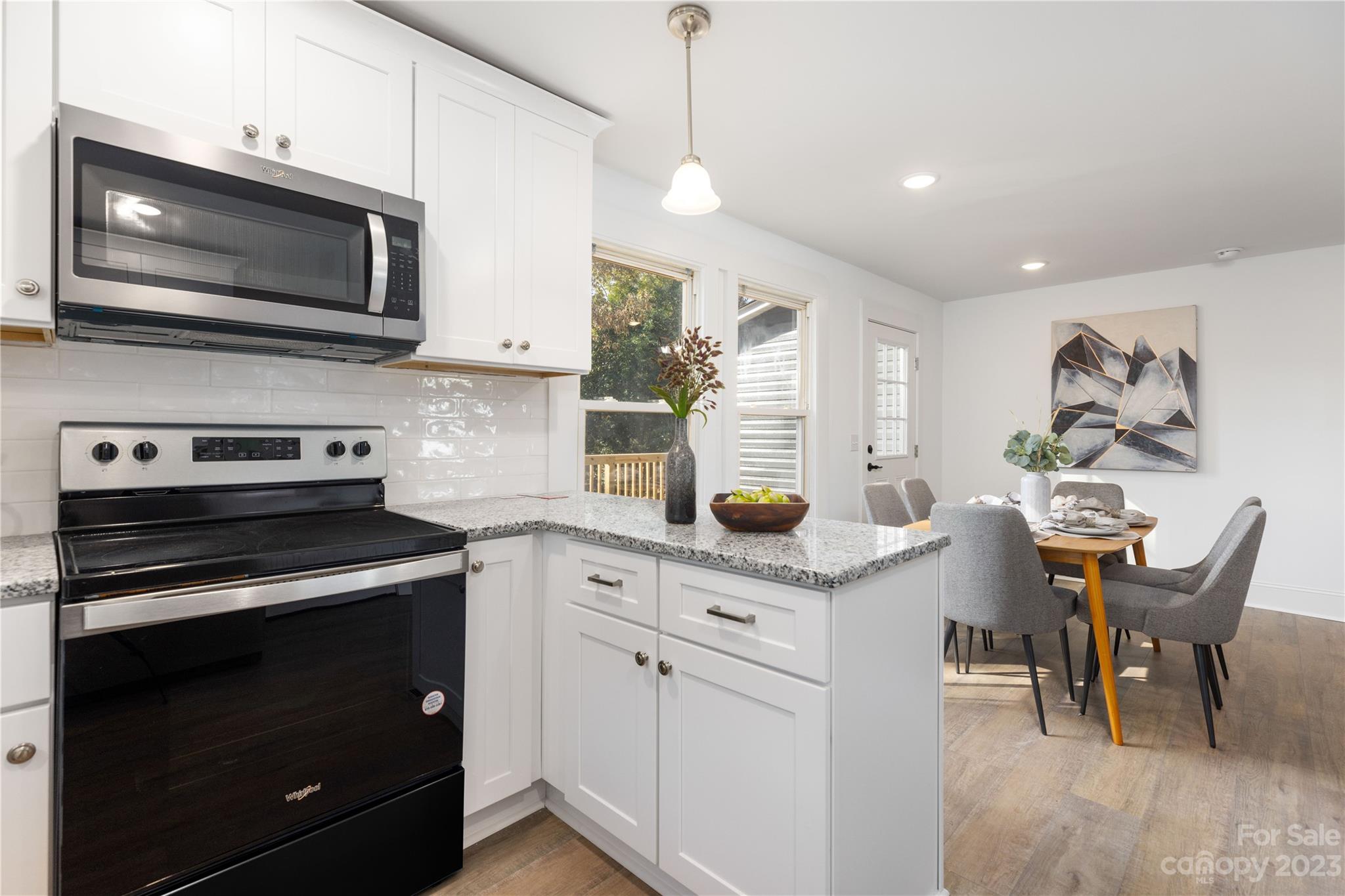 201 Hicks Circle Mount Holly, NC 28120 - Photo 10 of 23 a kitchen with stainless steel appliances a stove microwave and cabinets