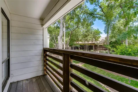 a view of a balcony with wooden floor