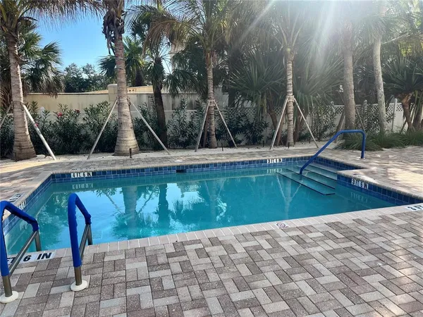 a view of a swimming pool with a yard