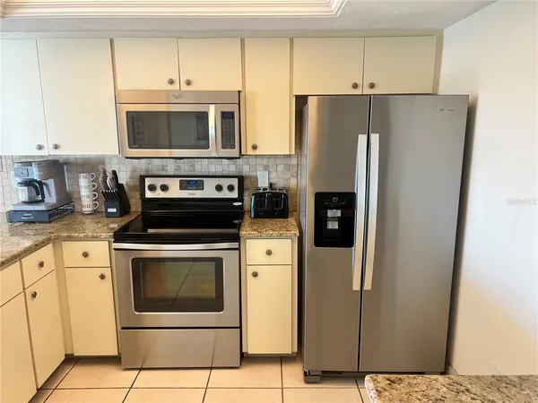a kitchen with a stove microwave and refrigerator