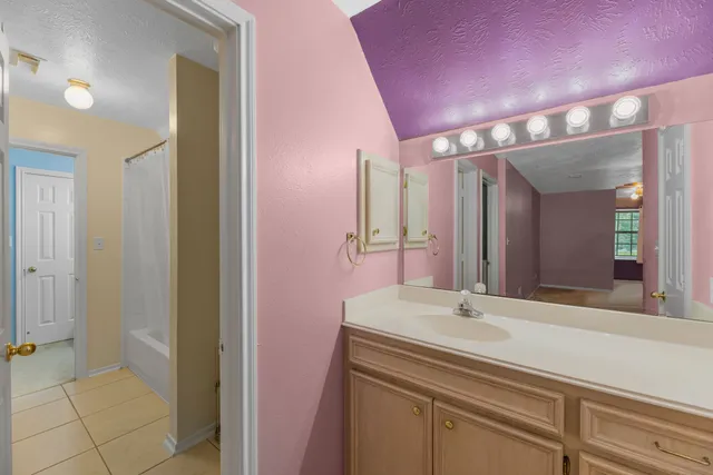 a bathroom with a bathtub a sink and a mirror