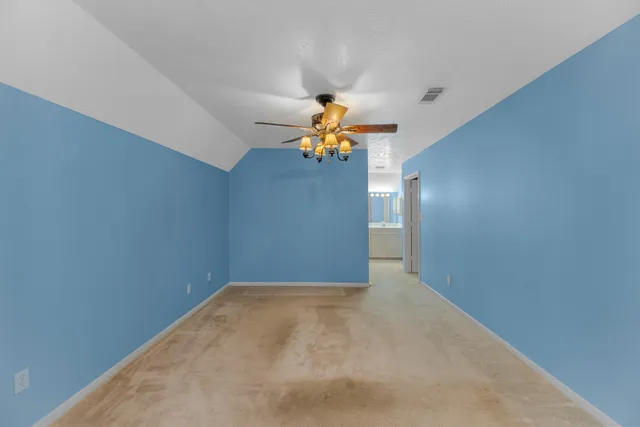 a view of an empty room with a fireplace and a window