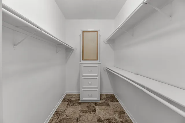 a view of an empty room with a fireplace and a window