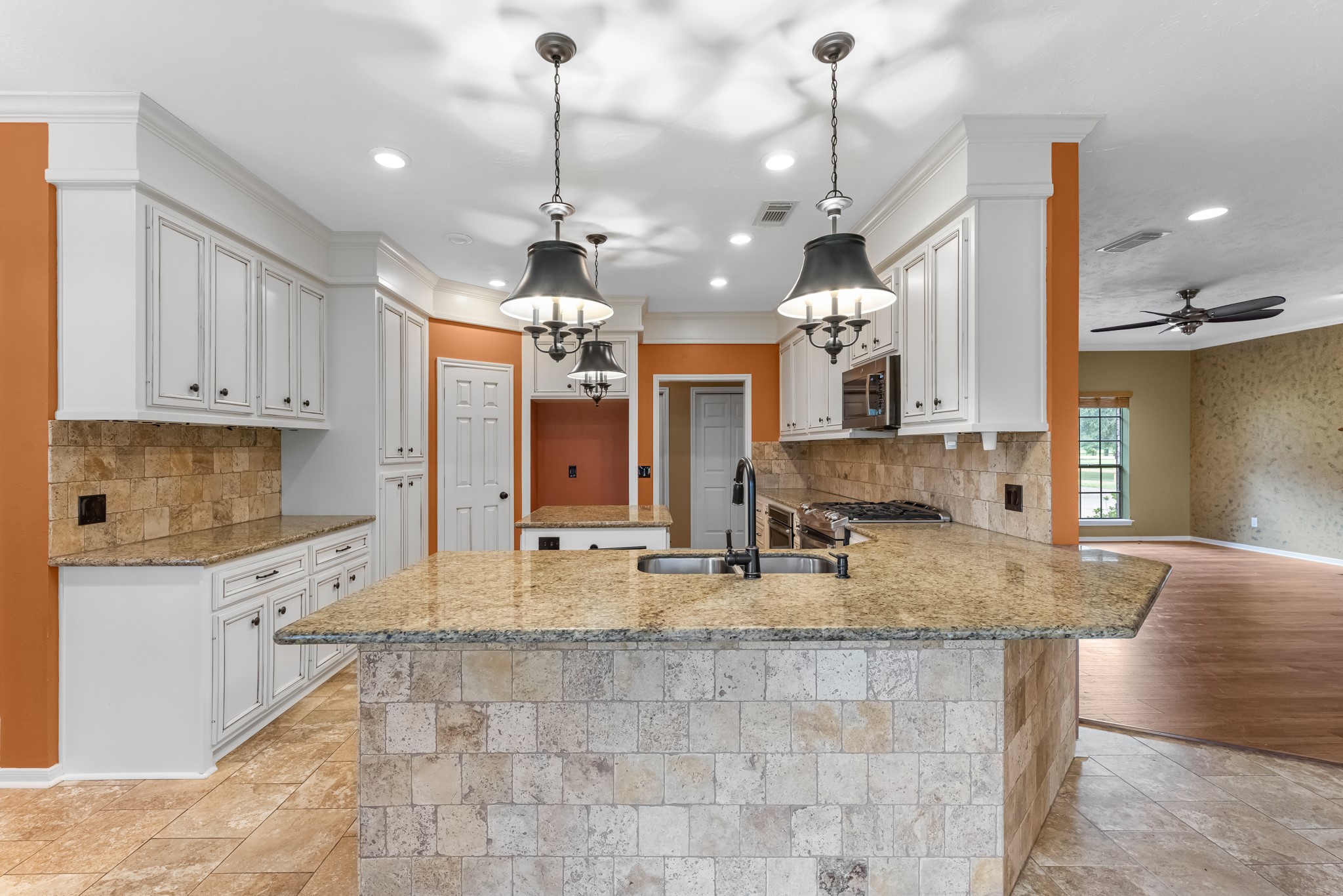 17126 County Road 39 Rosharon, TX 77583 - Photo 39 of 47 a kitchen with kitchen island granite countertop a sink a counter top space cabinets and stainless steel appliances