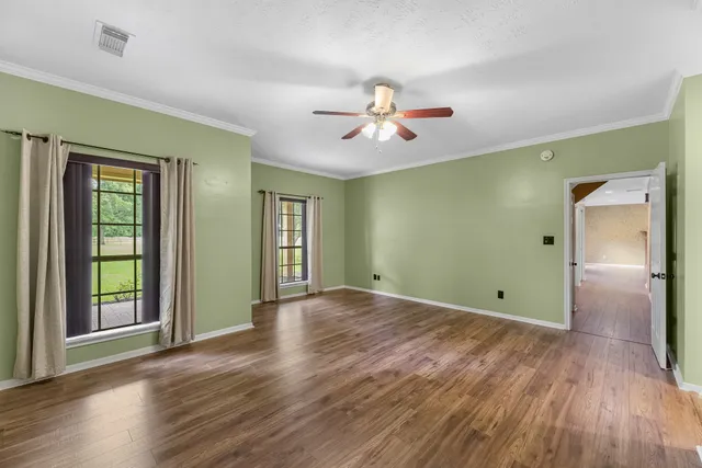 a spacious bathroom with a granite countertop double vanity sink a mirror and a shower