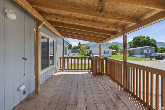 433 North 750 West Logan, UT 84321 - Photo 24 of 40 Covered wooden deck featuring a natural wood railing