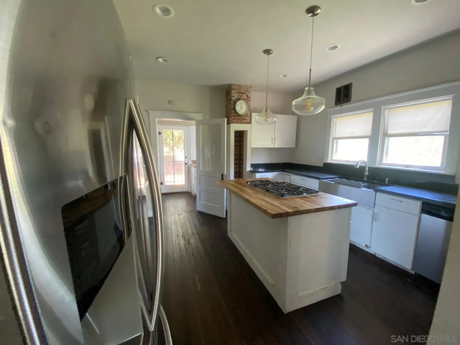 208 West 7th Avenue Escondido, CA 92025 - Photo 8 of 11 a kitchen with stainless steel appliances granite countertop a sink a stove and a refrigerator