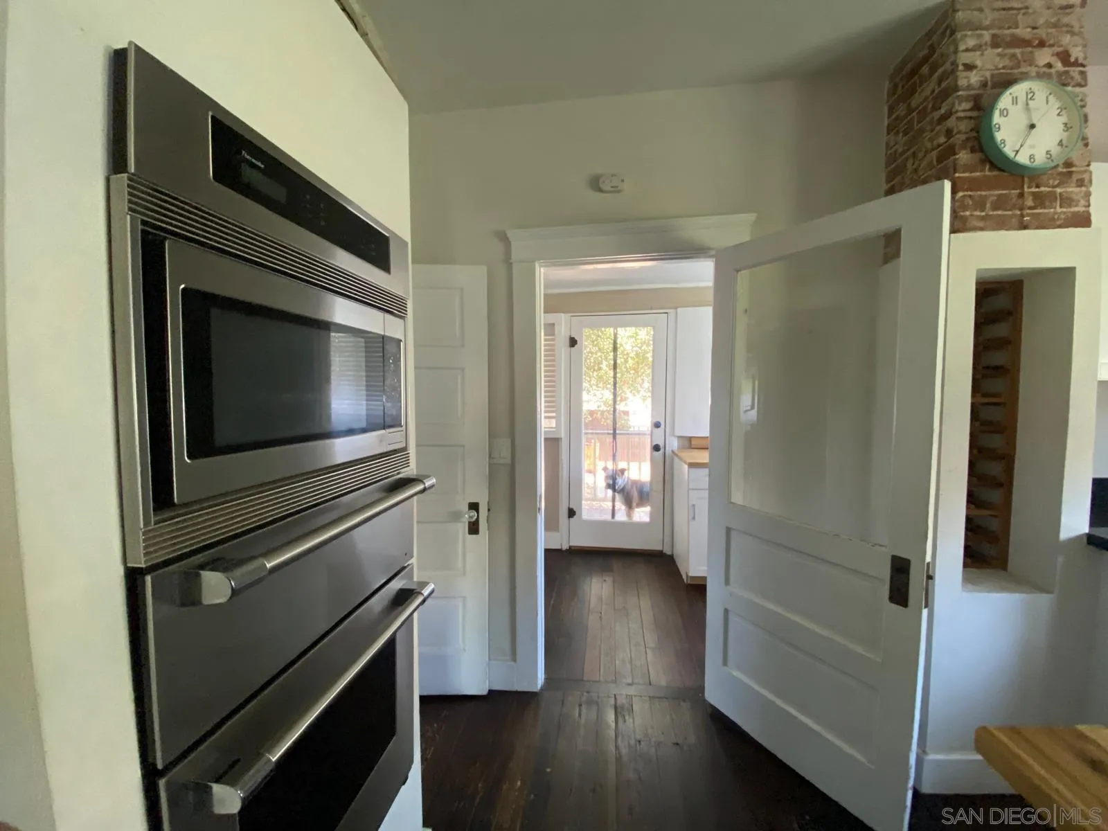 208 West 7th Avenue Escondido, CA 92025 - Photo 10 of 11 a kitchen with wooden floors and a fireplace