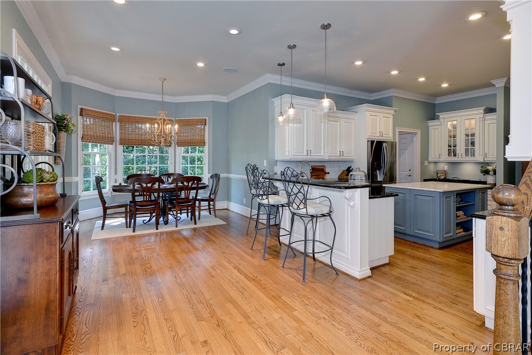 1632 River Ridge Williamsburg, VA 23185 - Photo 11 of 49 a open kitchen with stainless steel appliances granite countertop a stove top oven a dining table and chairs with wooden floor