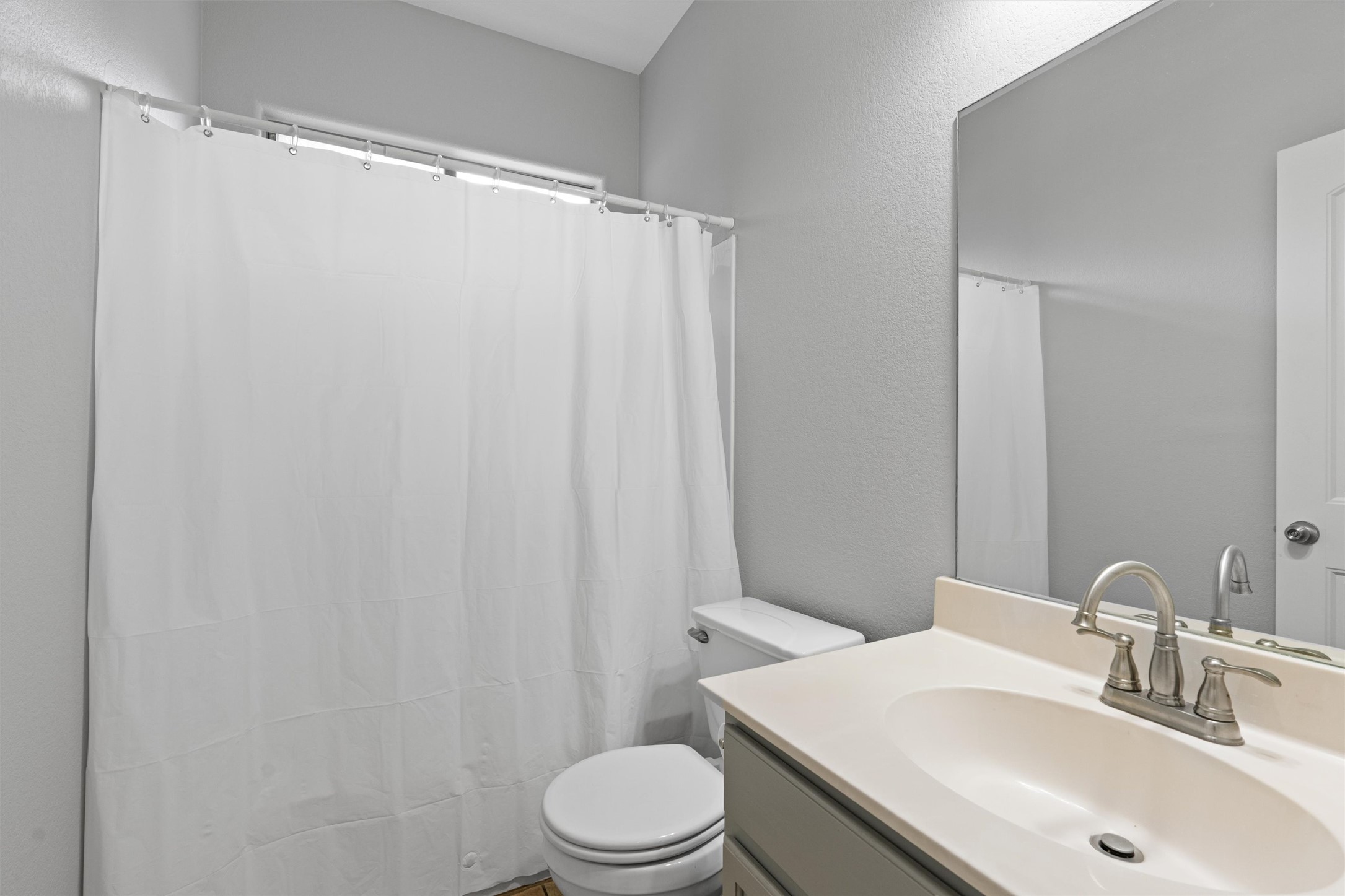 2240 Independence Drive, Unit A83 Austin, TX 78745 - Photo 16 of 34 a bathroom with a sink toilet and shower