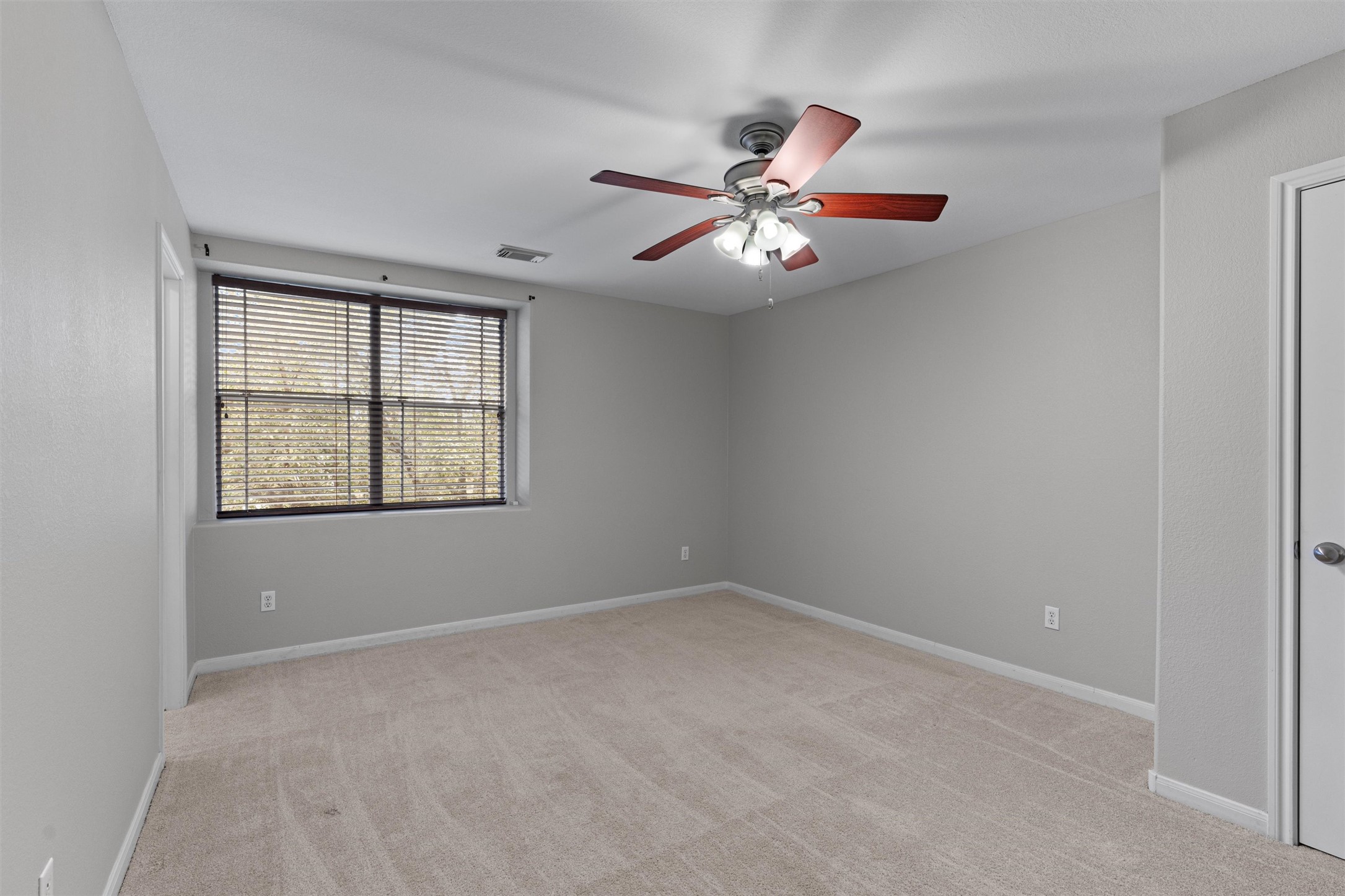 2240 Independence Drive, Unit A83 Austin, TX 78745 - Photo 22 of 34 an empty room with windows and fan