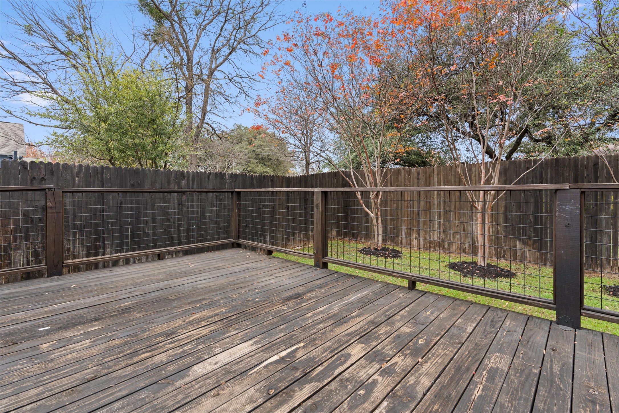 2240 Independence Drive, Unit A83 Austin, TX 78745 - Photo 27 of 34 a view of outdoor space with deck and large trees