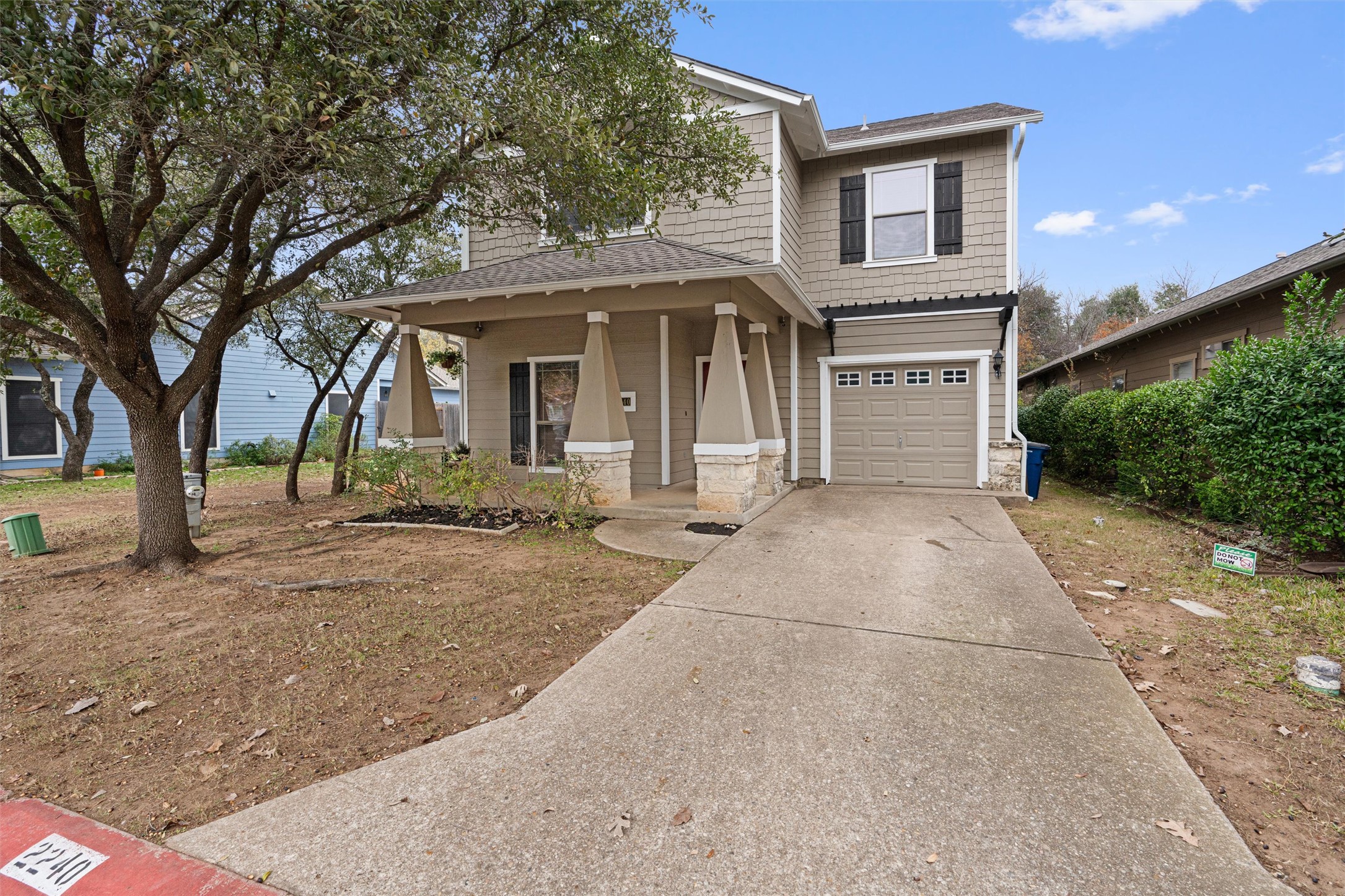 2240 Independence Drive, Unit A83 Austin, TX 78745 - Photo 3 of 34 a front view of a house with a yard and garage