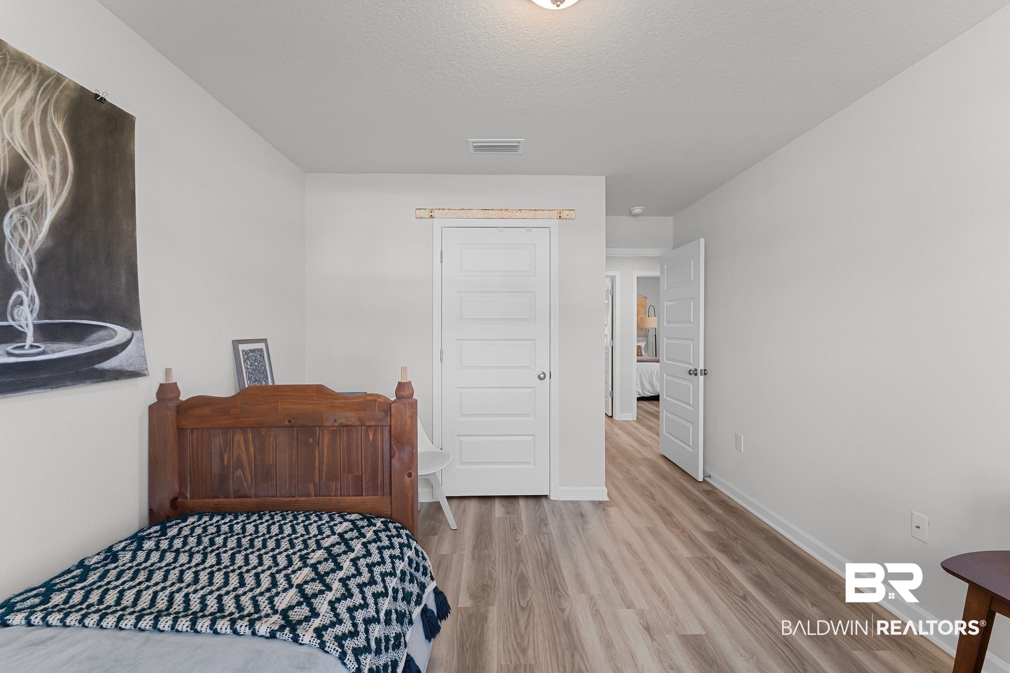 24337 Ringneck Loop Elberta, AL 36530 - Photo 24 of 34 Bedroom with light wood-style floors and a textured ceiling