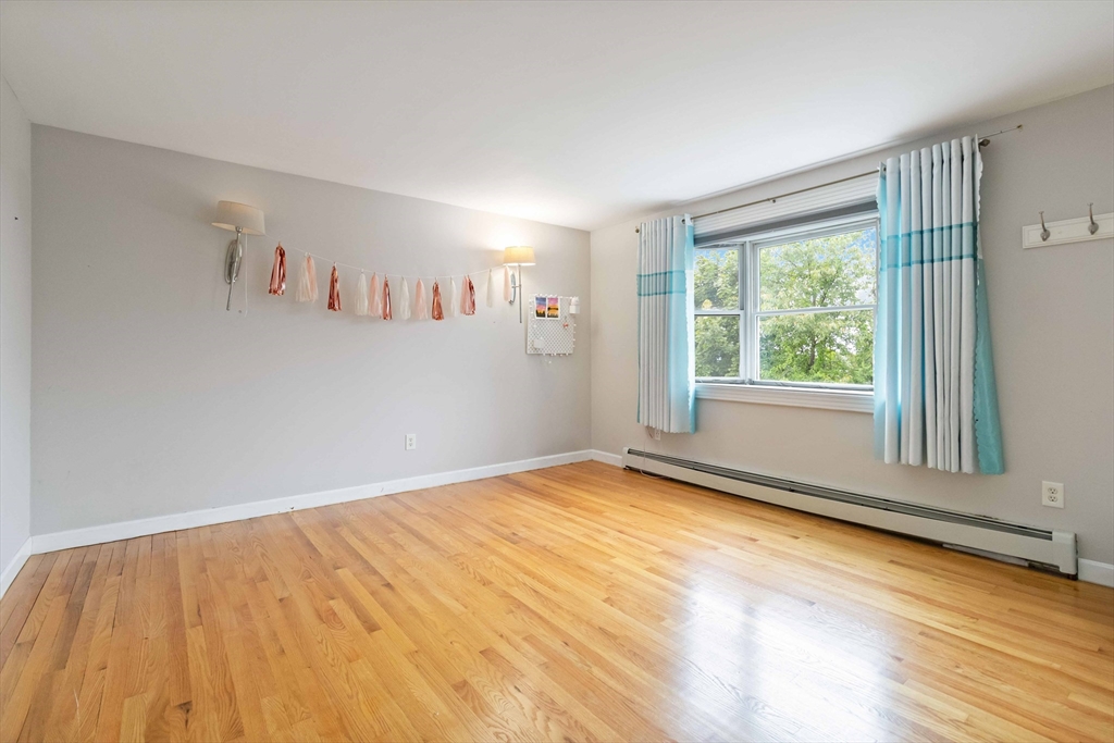 141 Gardiner Road Quincy, MA 02169 - Photo 23 of 35 a view of an empty room with a window and wooden floor