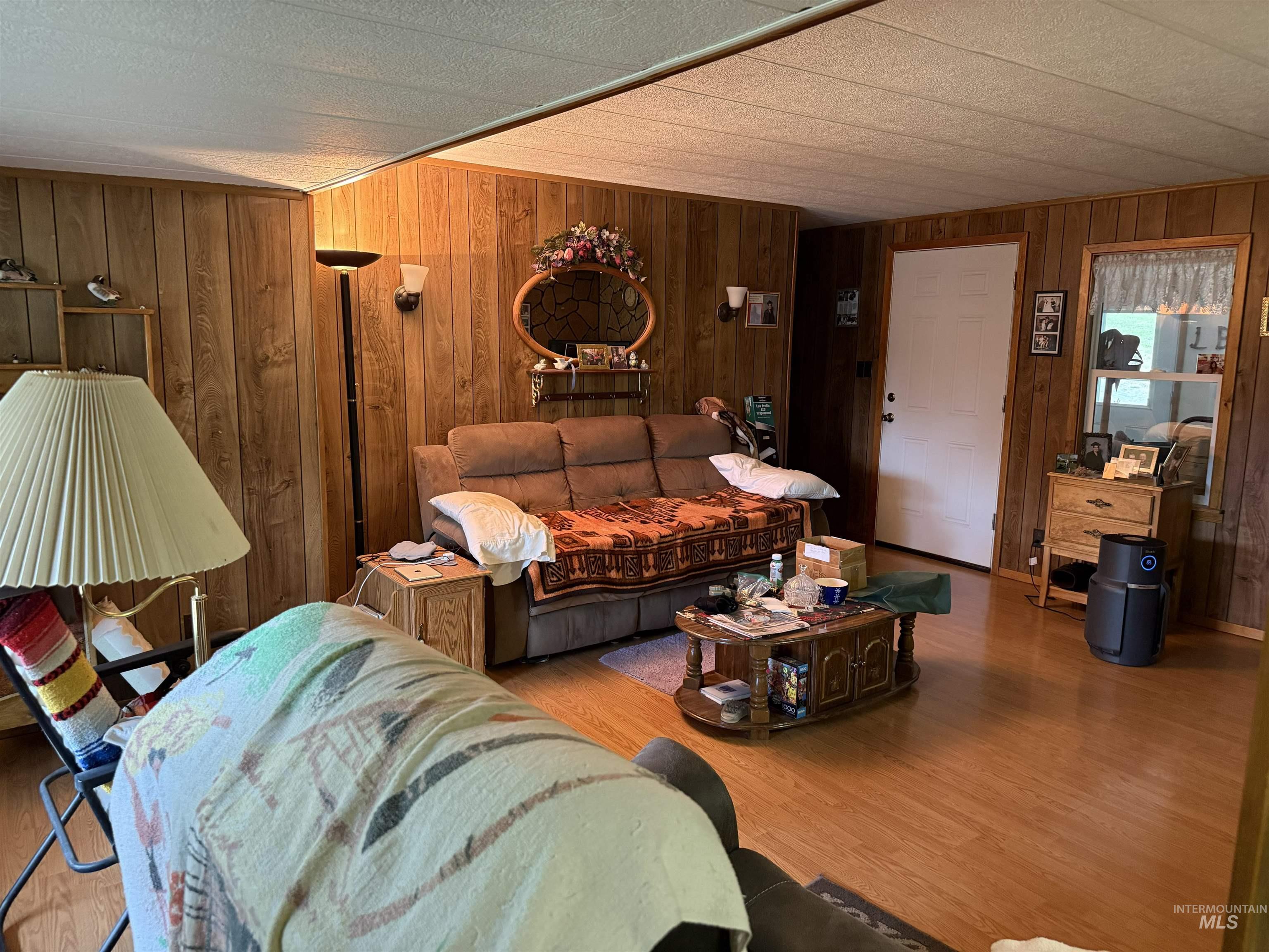 733 Pleasant Valley Road Stites, ID 83552 - Photo 8 of 46 Interior living area featuring wood-finish wall paneling and wood-finish flooring