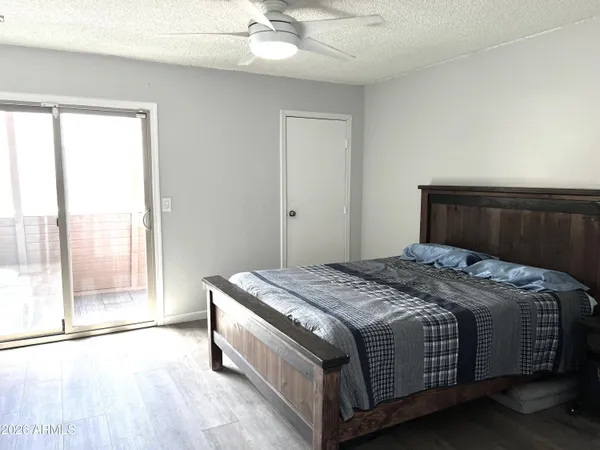 a bedroom with a bed and a large window