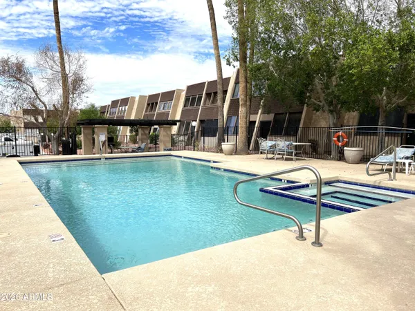 a view of a swimming pool with lounge chair