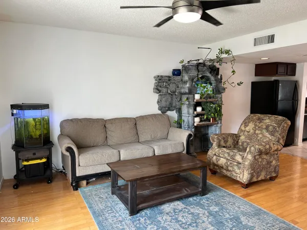 a living room with furniture and a chandelier