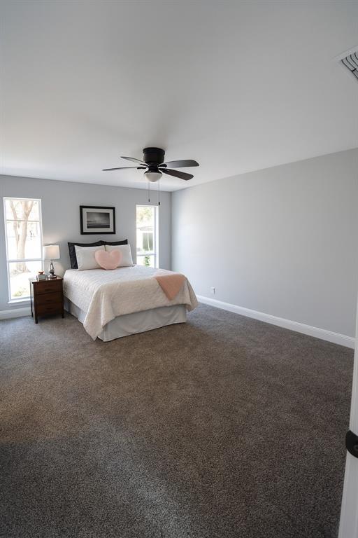 7210 Lakeshore Drive Rowlett, TX 75089 - Photo 7 of 15 a bedroom with a bed and a night stand