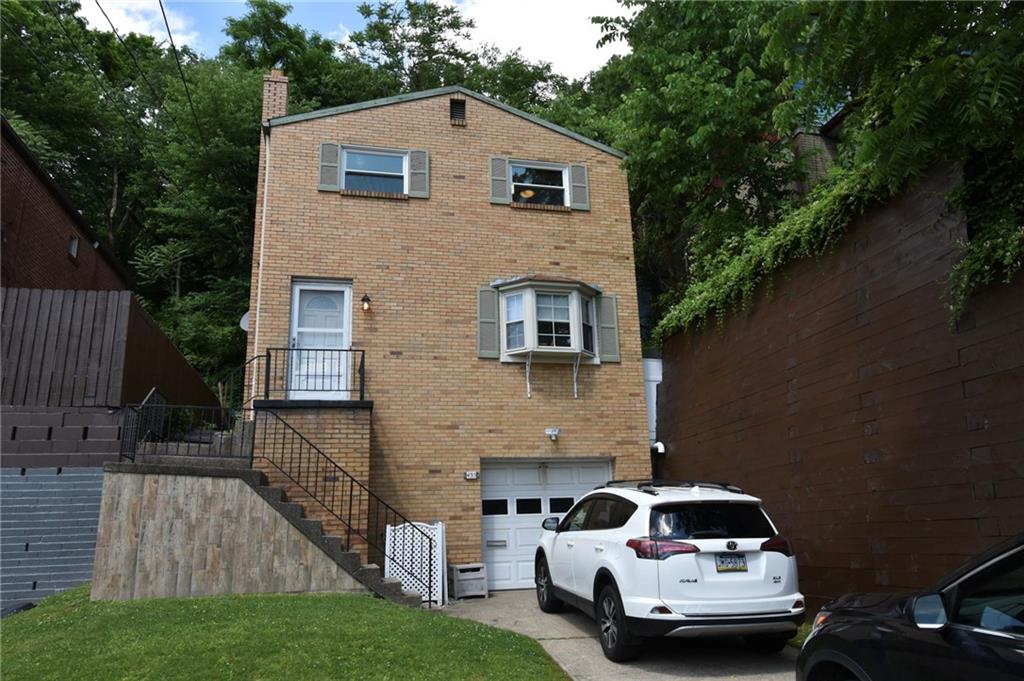 a car parked in front of a white house