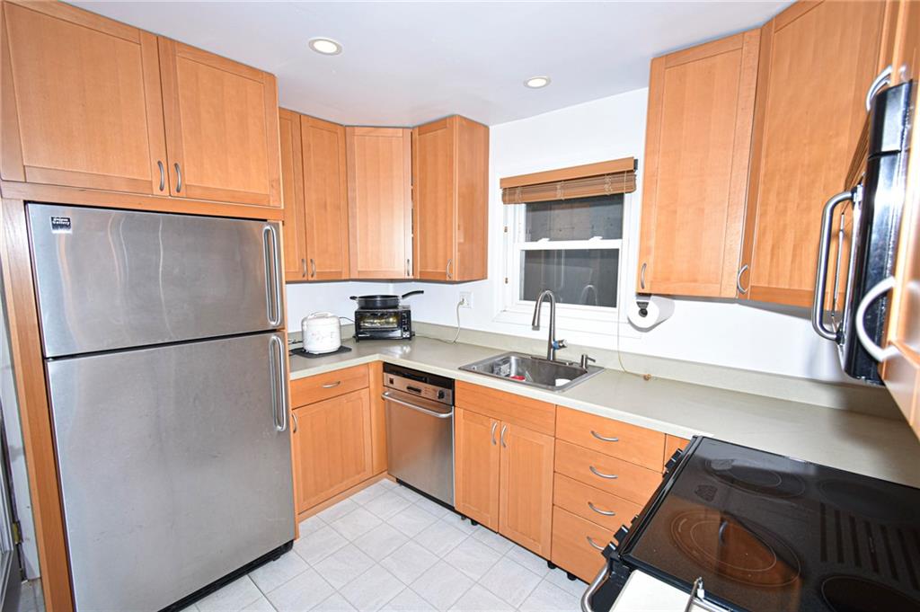 435 Elmer Street Edgewood, PA 15218 - Photo 6 of 16 a kitchen with stainless steel appliances granite countertop a refrigerator and a sink