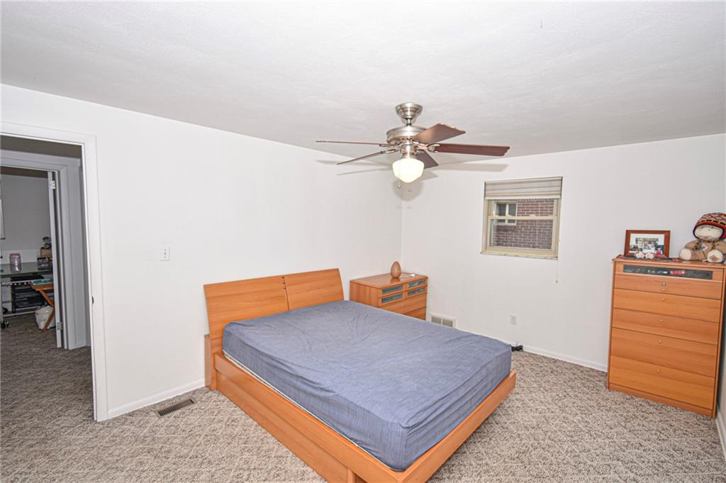 435 Elmer Street Edgewood, PA 15218 - Photo 9 of 16 a blue bed sitting in a room next to a window