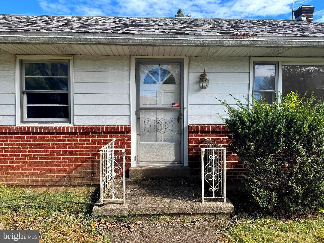 1533 School Road Hatfield, PA 19440 - Photo 2 of 13 a stone house with potted plants in front of it