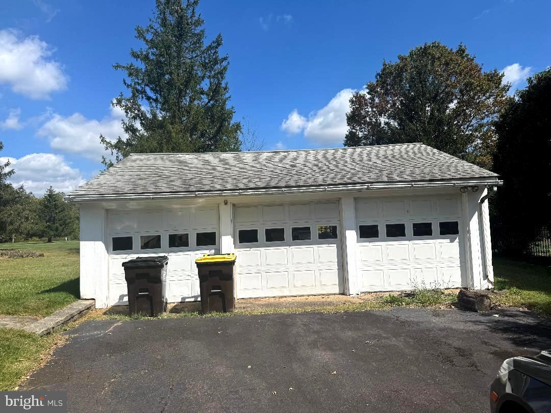 1533 School Road Hatfield, PA 19440 - Photo 3 of 13 a view of a white house with large windows and a table and chairs