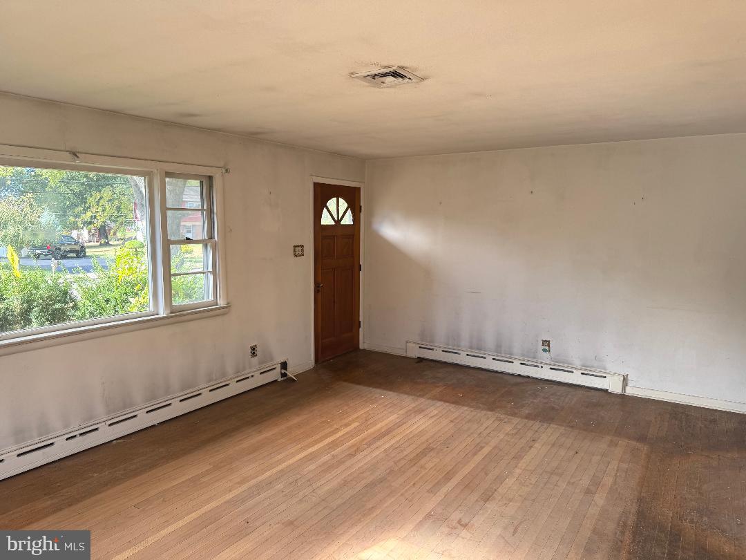 1533 School Road Hatfield, PA 19440 - Photo 8 of 13 an empty room with wooden floor and windows